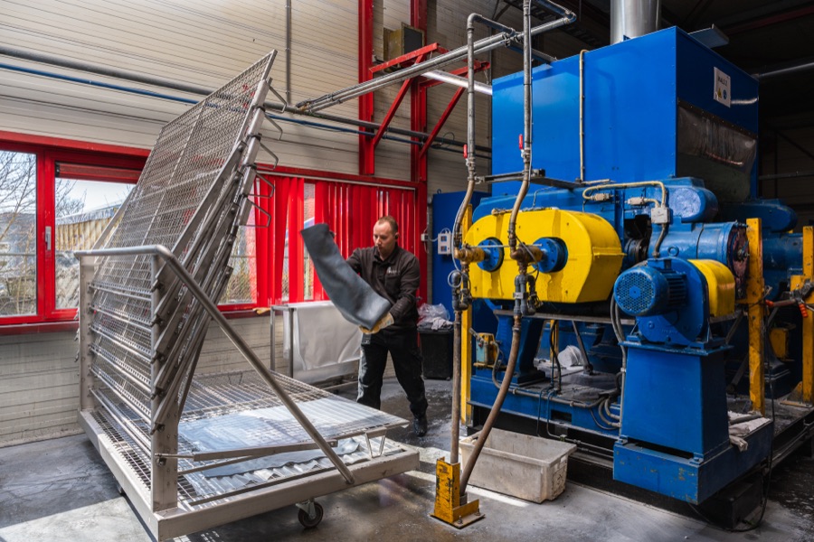 Polycomp specialist handling a custom rubber sheet